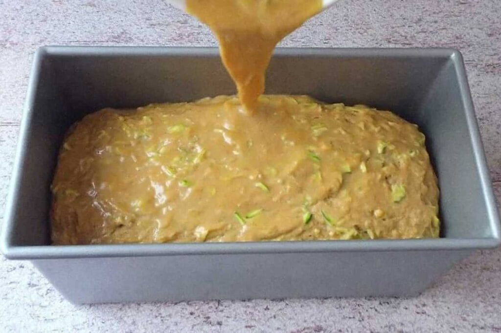 Pouring zucchini bread batter into pan